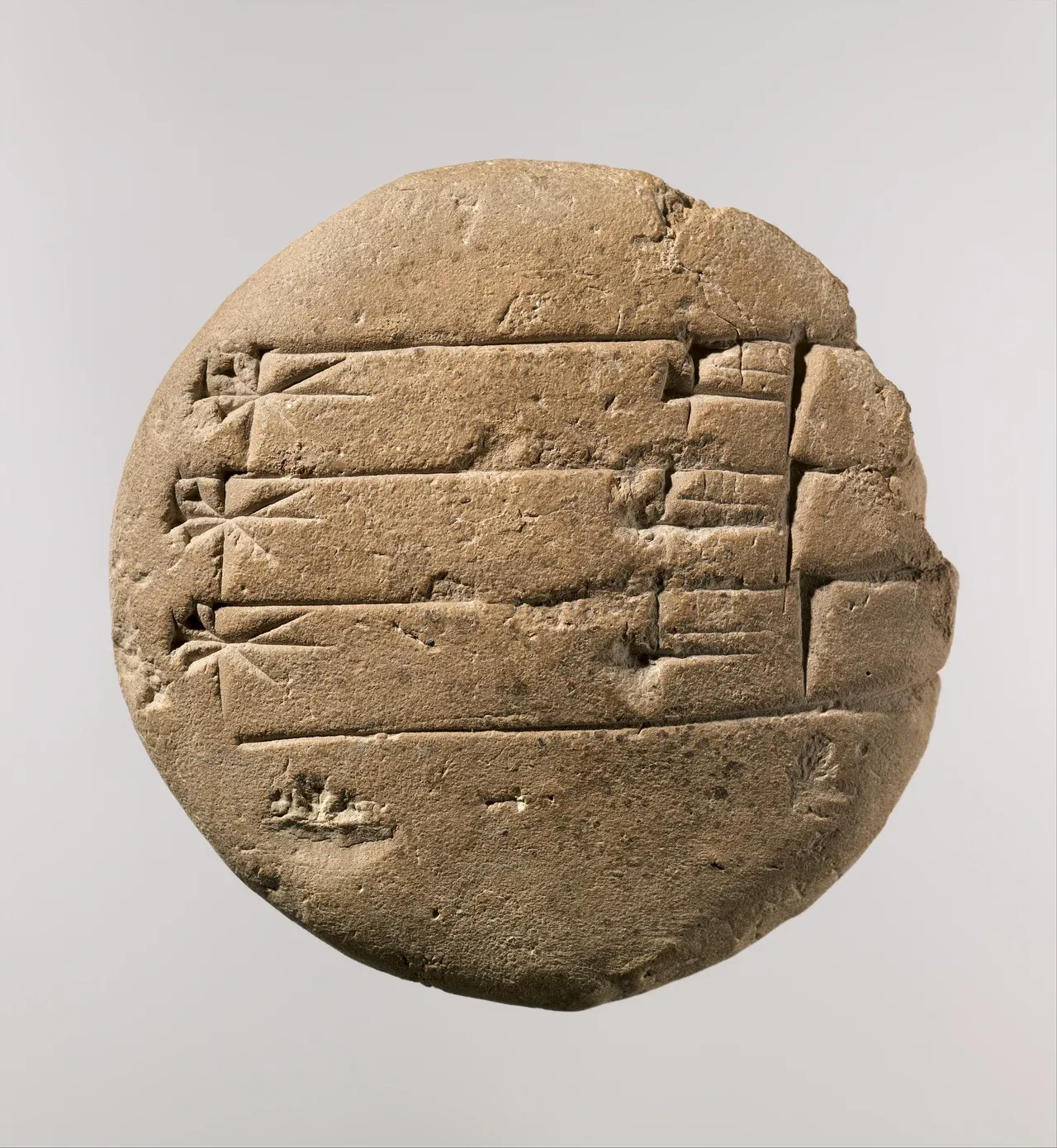 A round clay school tablet bearing six repetitions of the cuneiform signs for the divine name Urash.